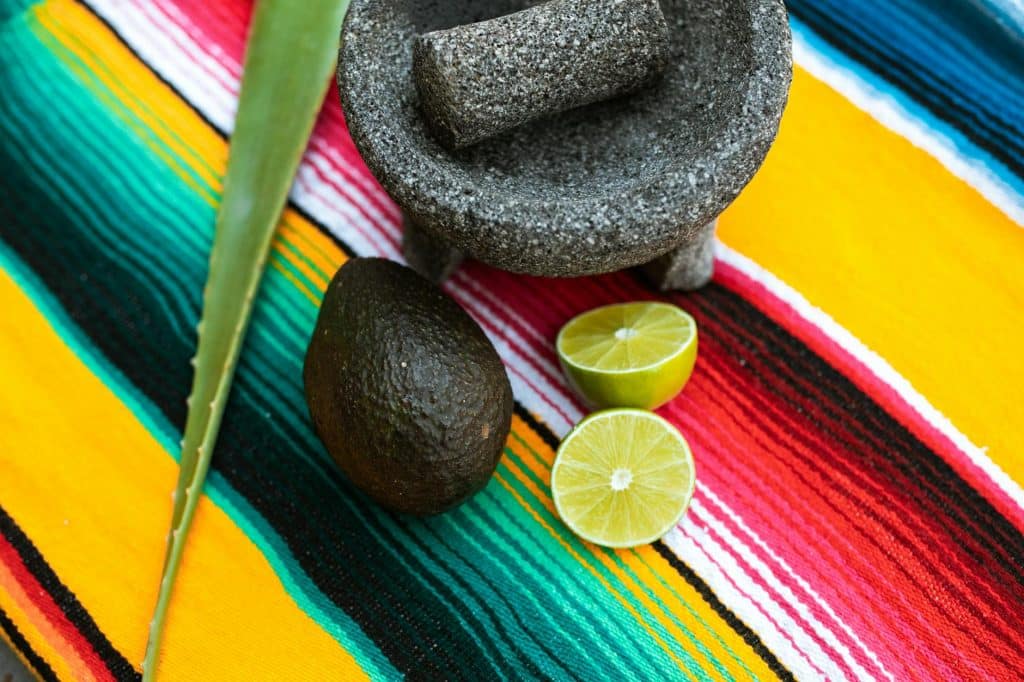 stone mortar and pestle beside sliced lemon